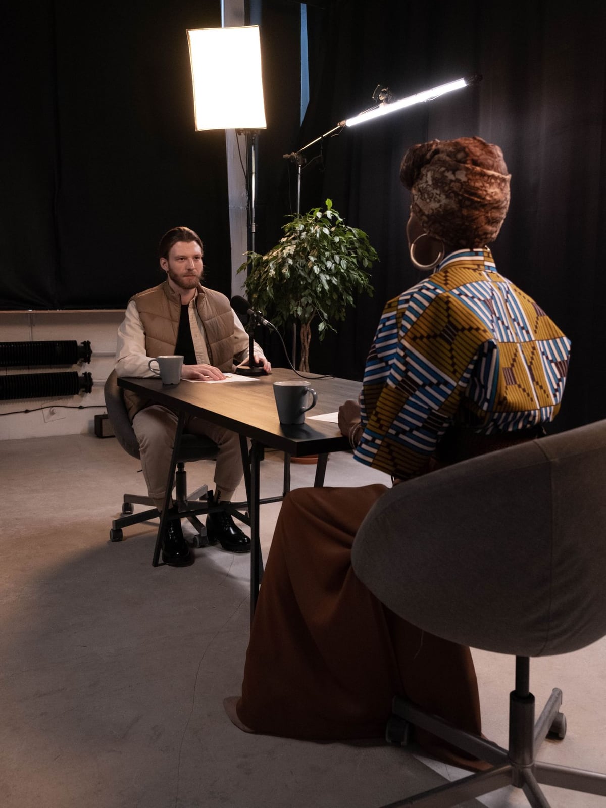 An editor conducting a corporate interview in a modern Montreal loft setting.