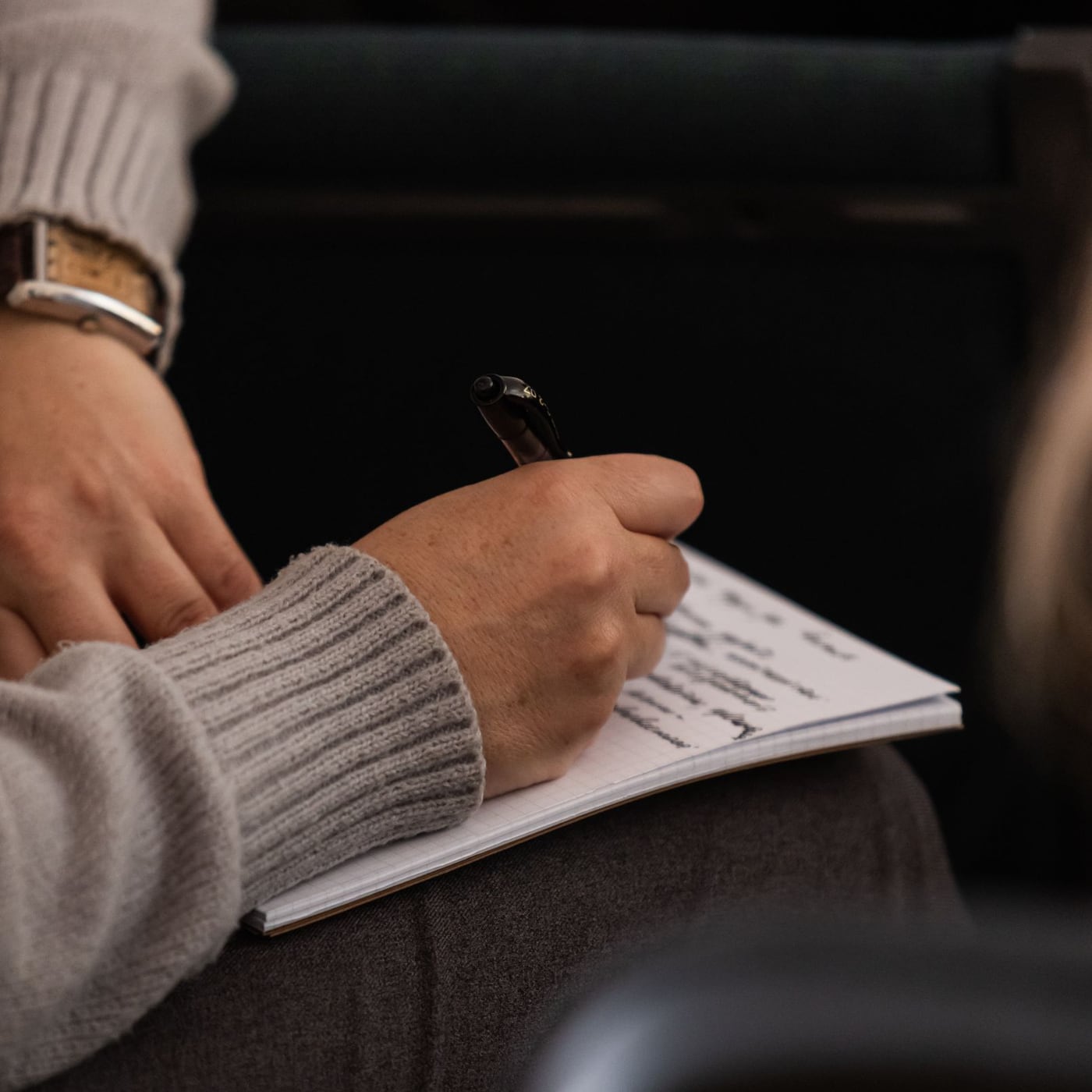 Close-up of a hand correcting a printed text with a professional pen.